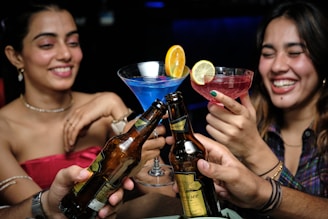 A joyful group of guests toasting with drinks at a wedding reception.