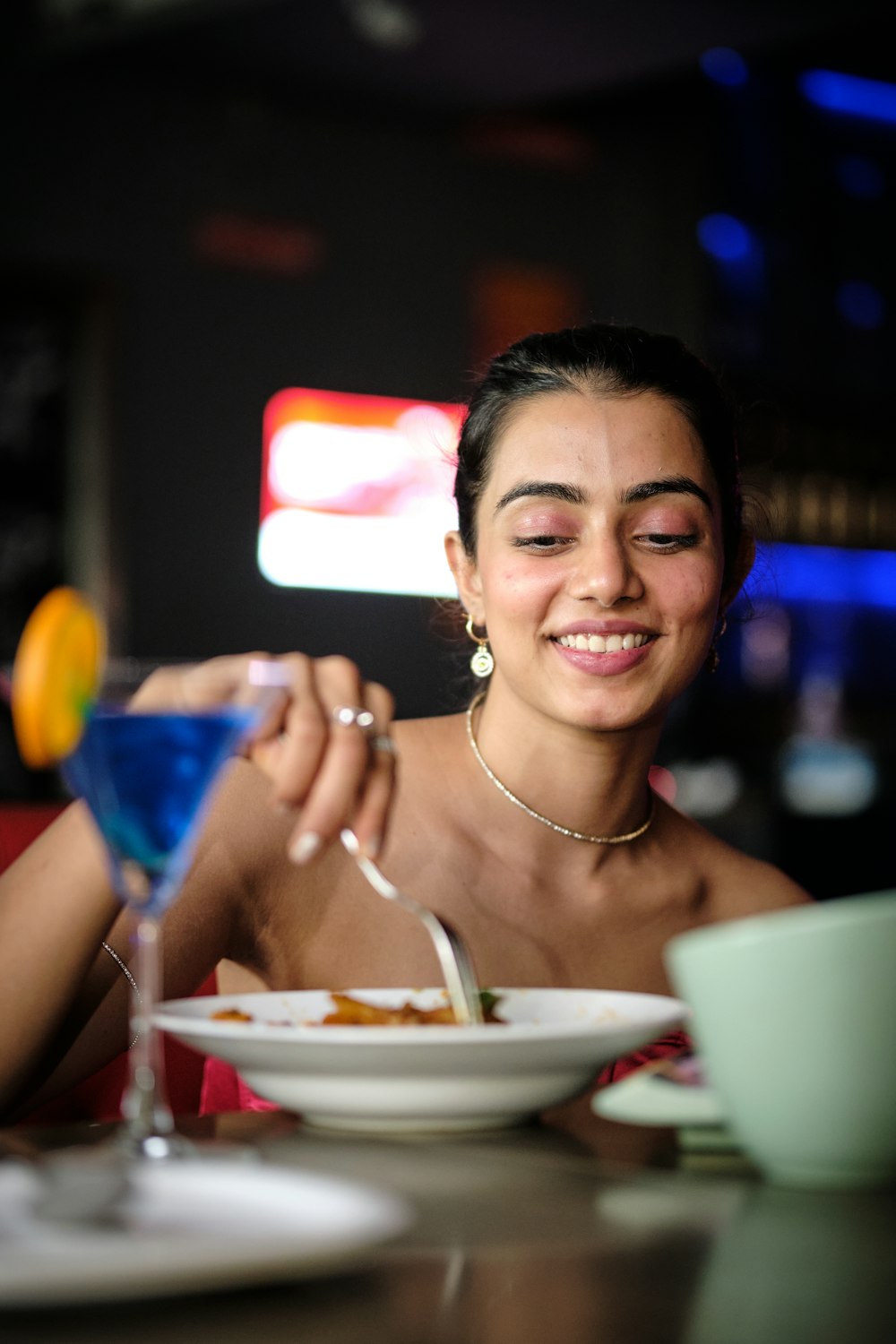 a woman sitting at a table with a plate of food