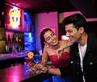 a man and a woman sitting at a bar