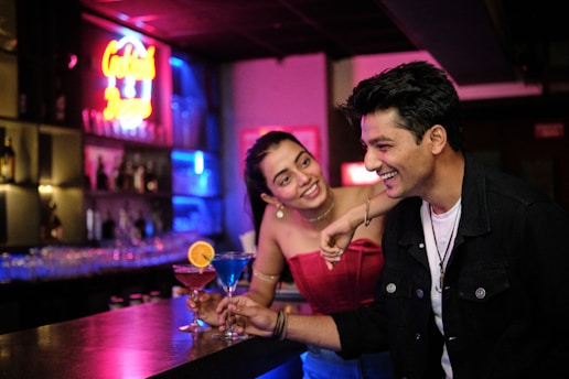 a man and a woman sitting at a bar