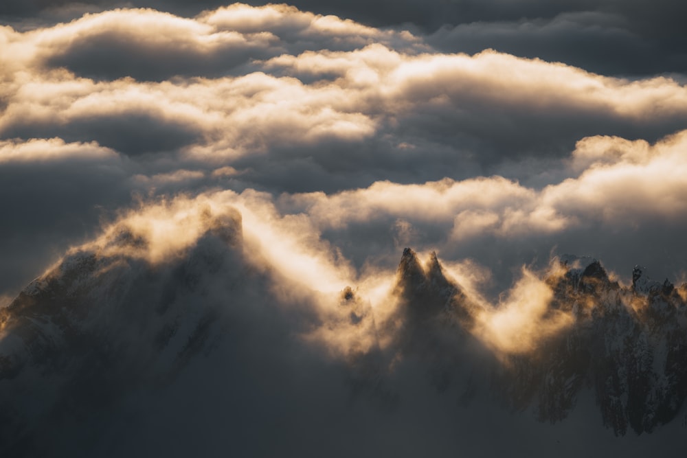 a view of a mountain range covered in clouds