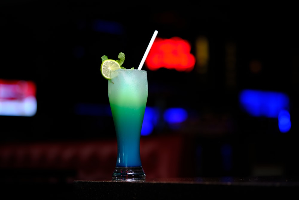 a blue and green drink sitting on top of a table