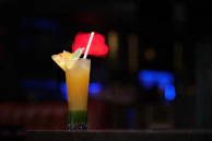 Refreshing tropical cocktail with colorful layers and a garnish of pineapple and mint.