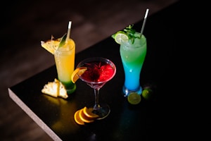 three different types of drinks sitting on a table