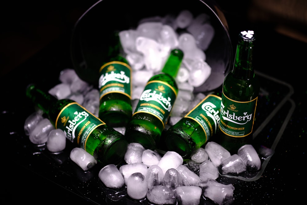 a group of beer bottles sitting on top of ice