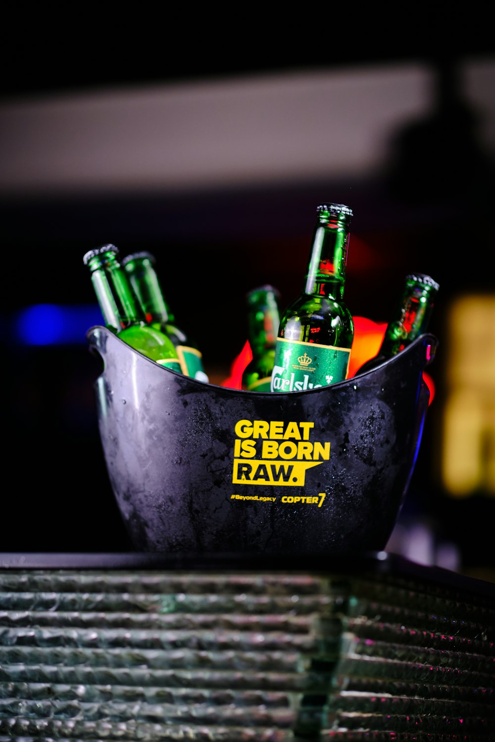 a bucket full of beer sitting on top of a table