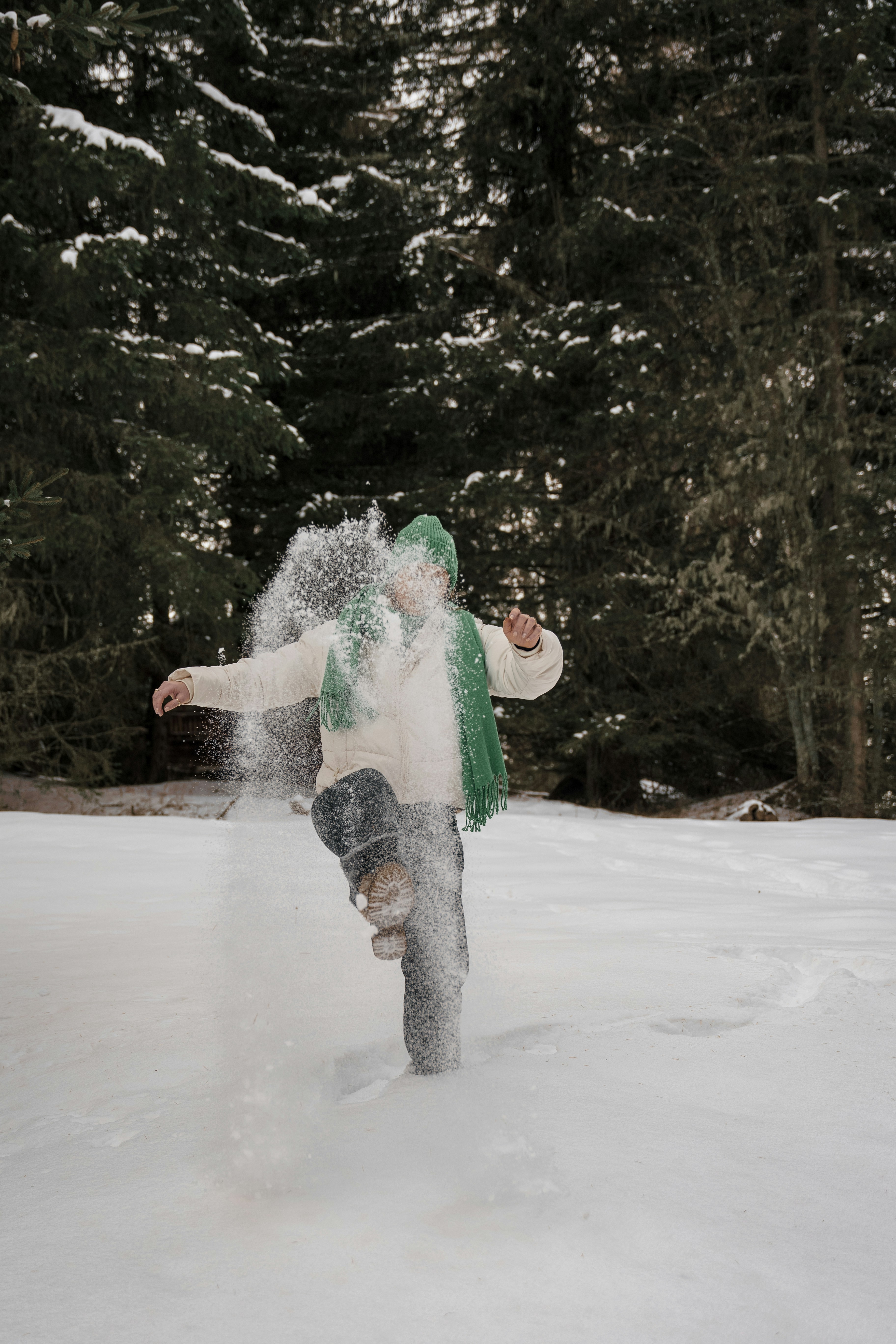a man riding a snowboard down a snow covered slope