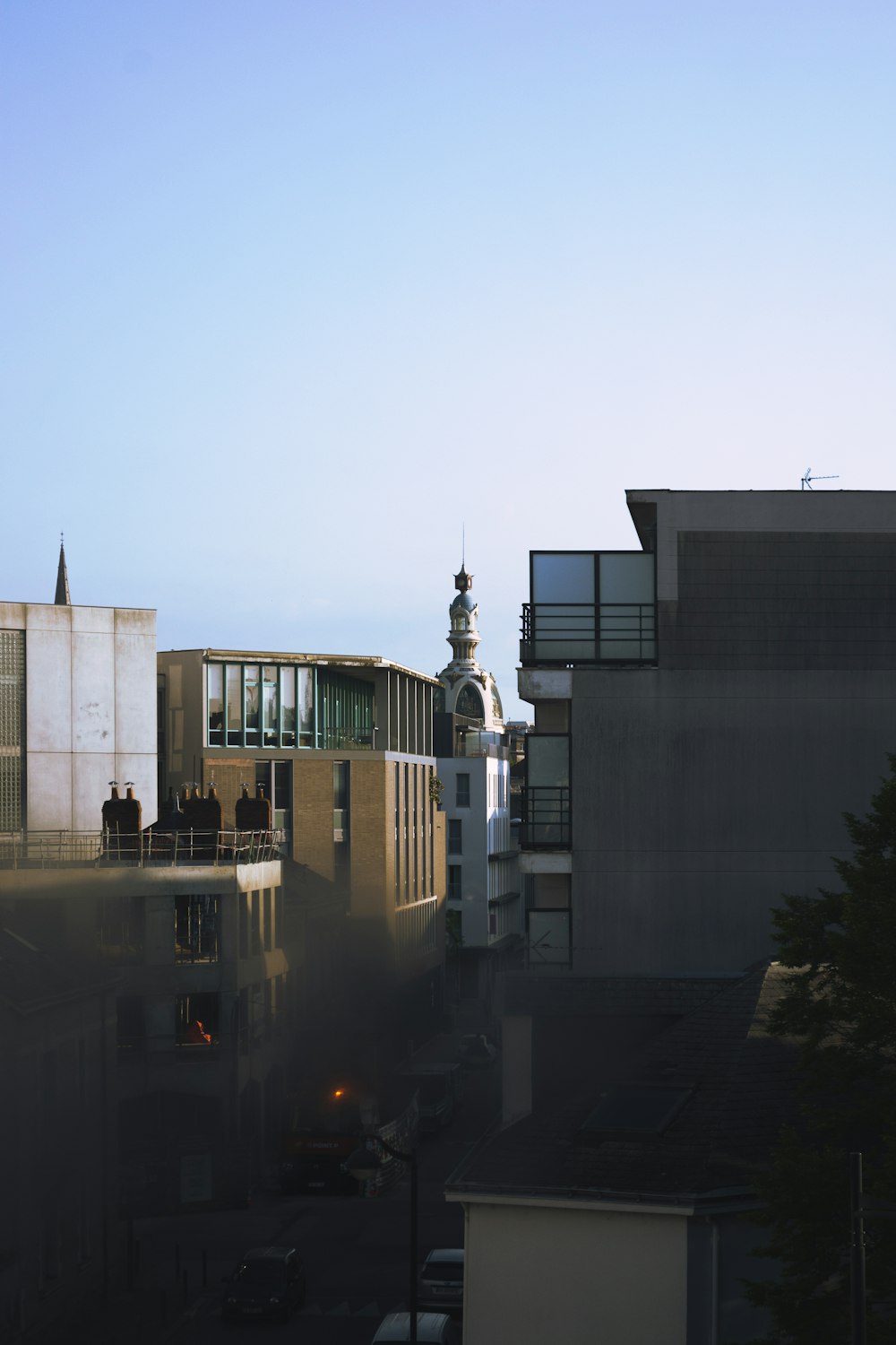 a view of a building with a clock tower in the background