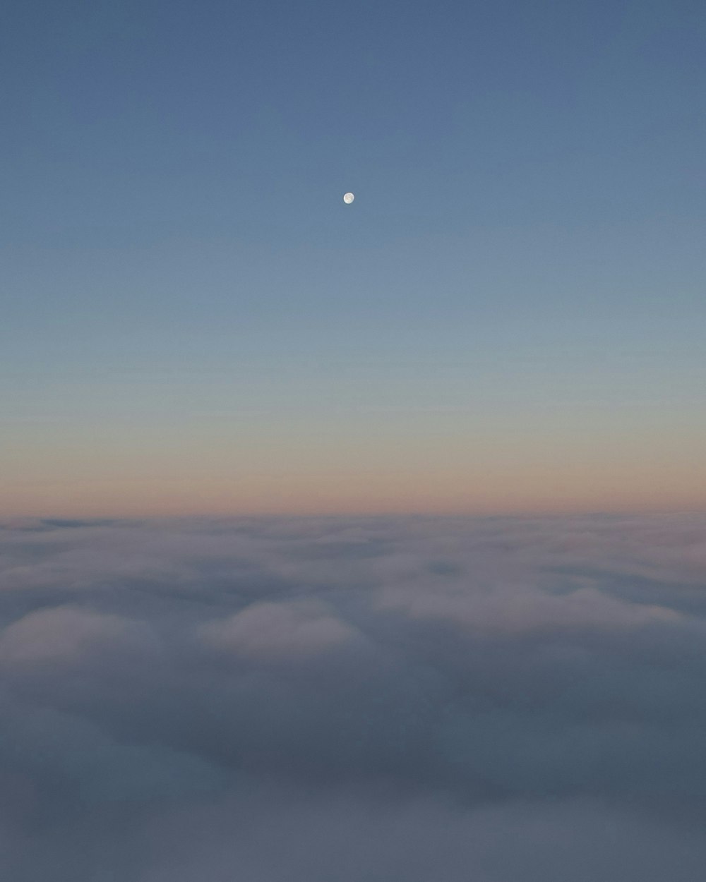 a view of the moon above the clouds