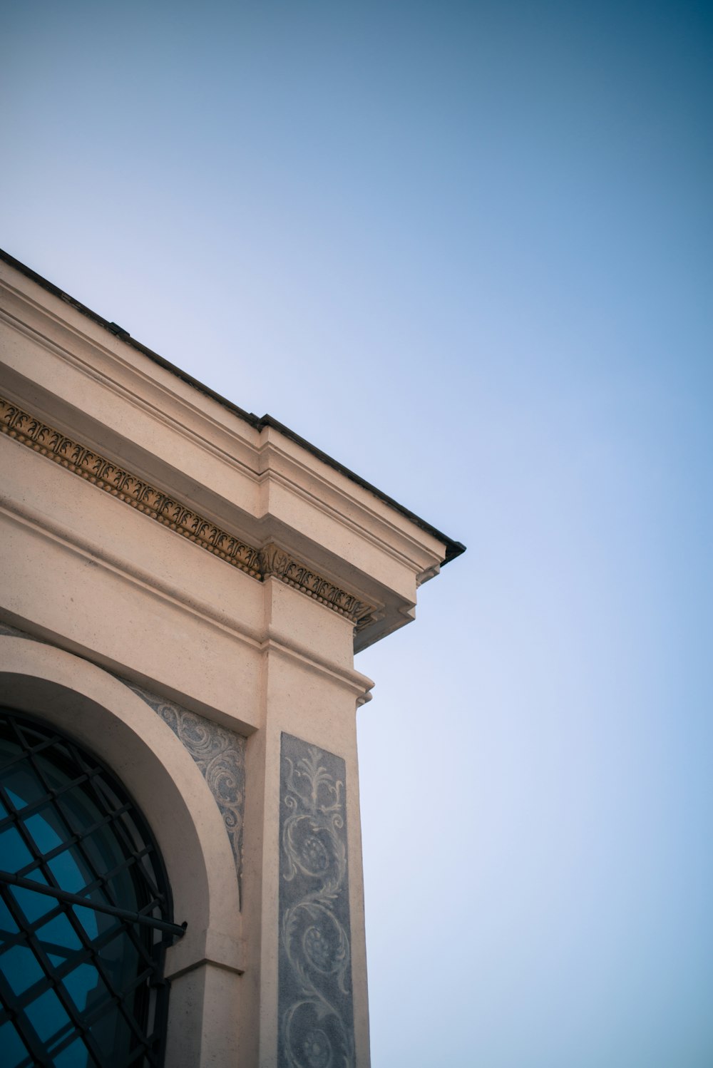 a clock on the side of a building with a blue sky in the background