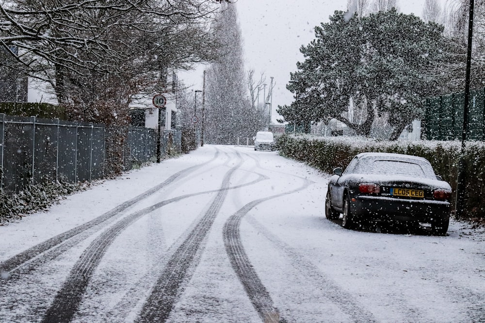 a car is parked on a snowy street