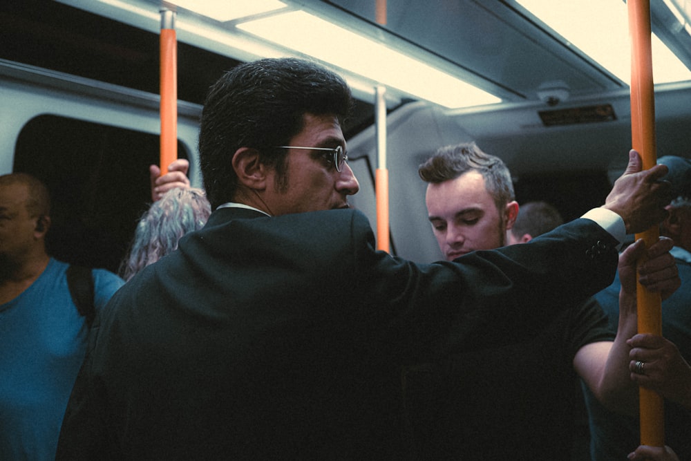 a group of people riding on a subway train