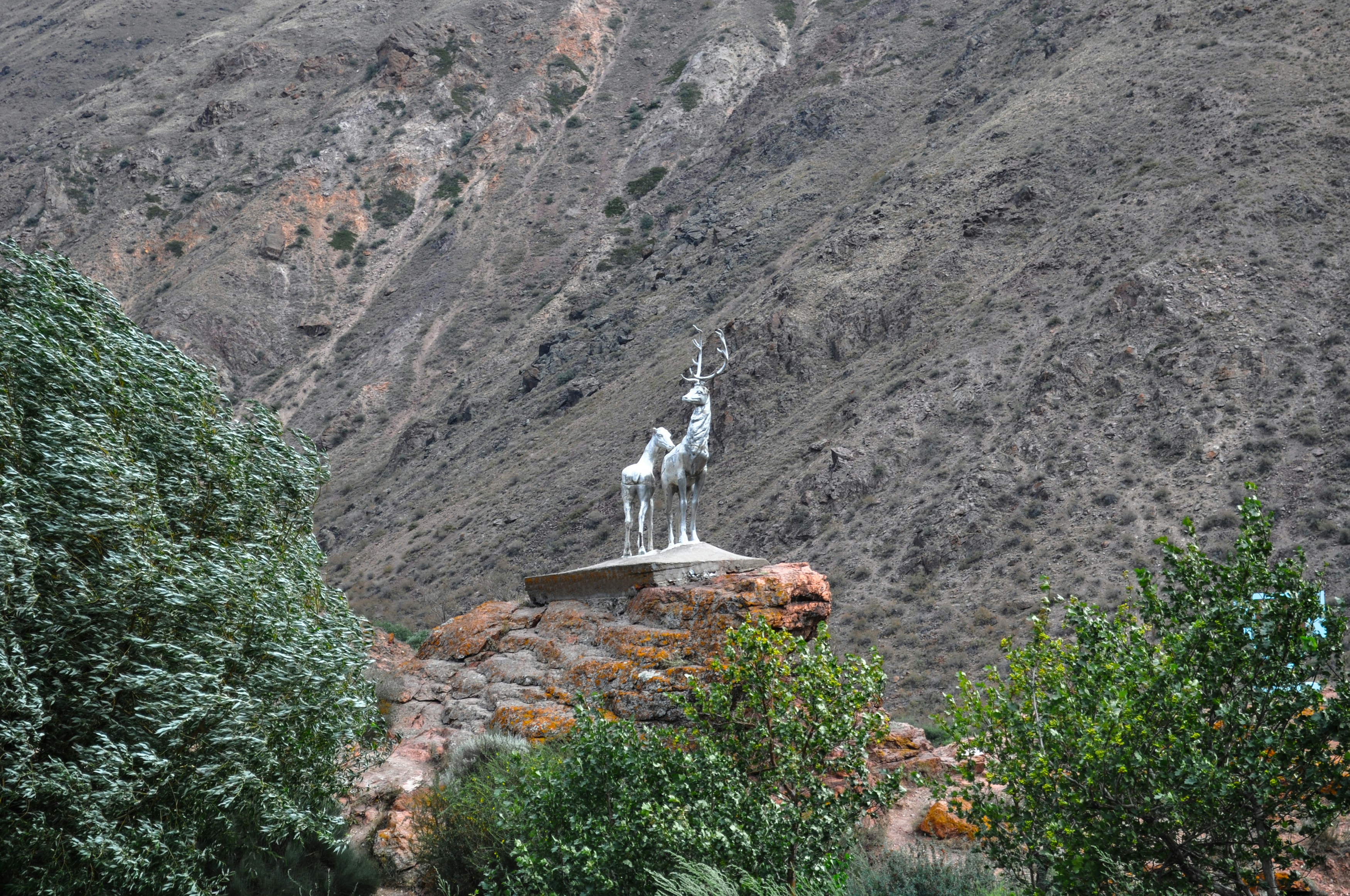 a statue of a man riding a horse on top of a hill