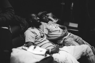 a couple of men sitting next to each other