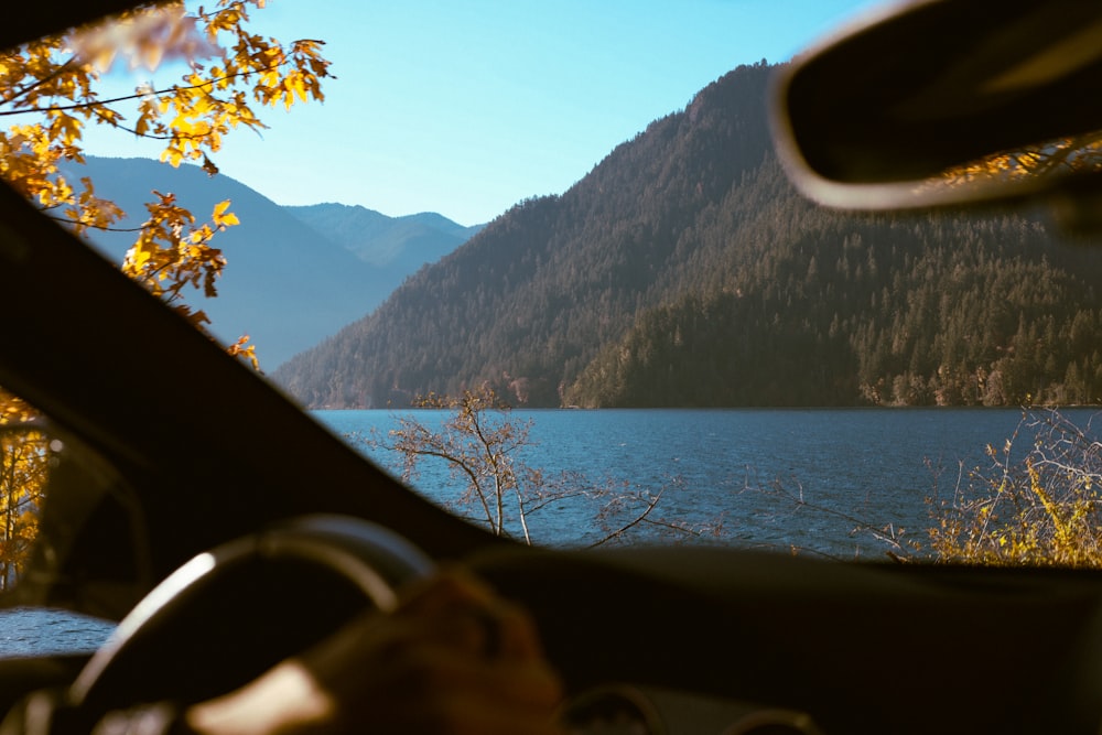 a view of a lake from inside a car