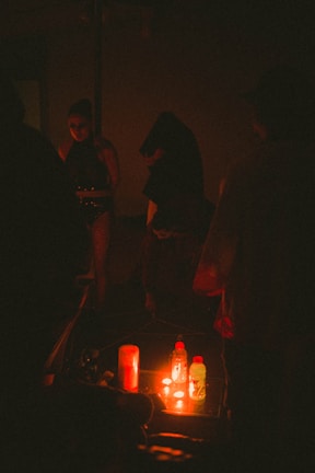 a group of people standing around a table in the dark
