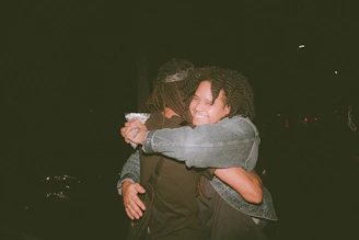 A warm, comforting scene of two people reconnecting and smiling during a counseling session.