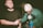 A close-up of a satisfied customer shaking hands with a craftsman in a workshop.