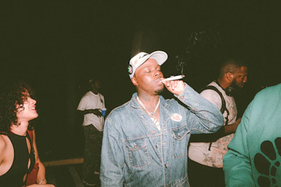 A group of friends sharing cigars around a cozy fire, their faces lit with smiles and meaningful conversation.