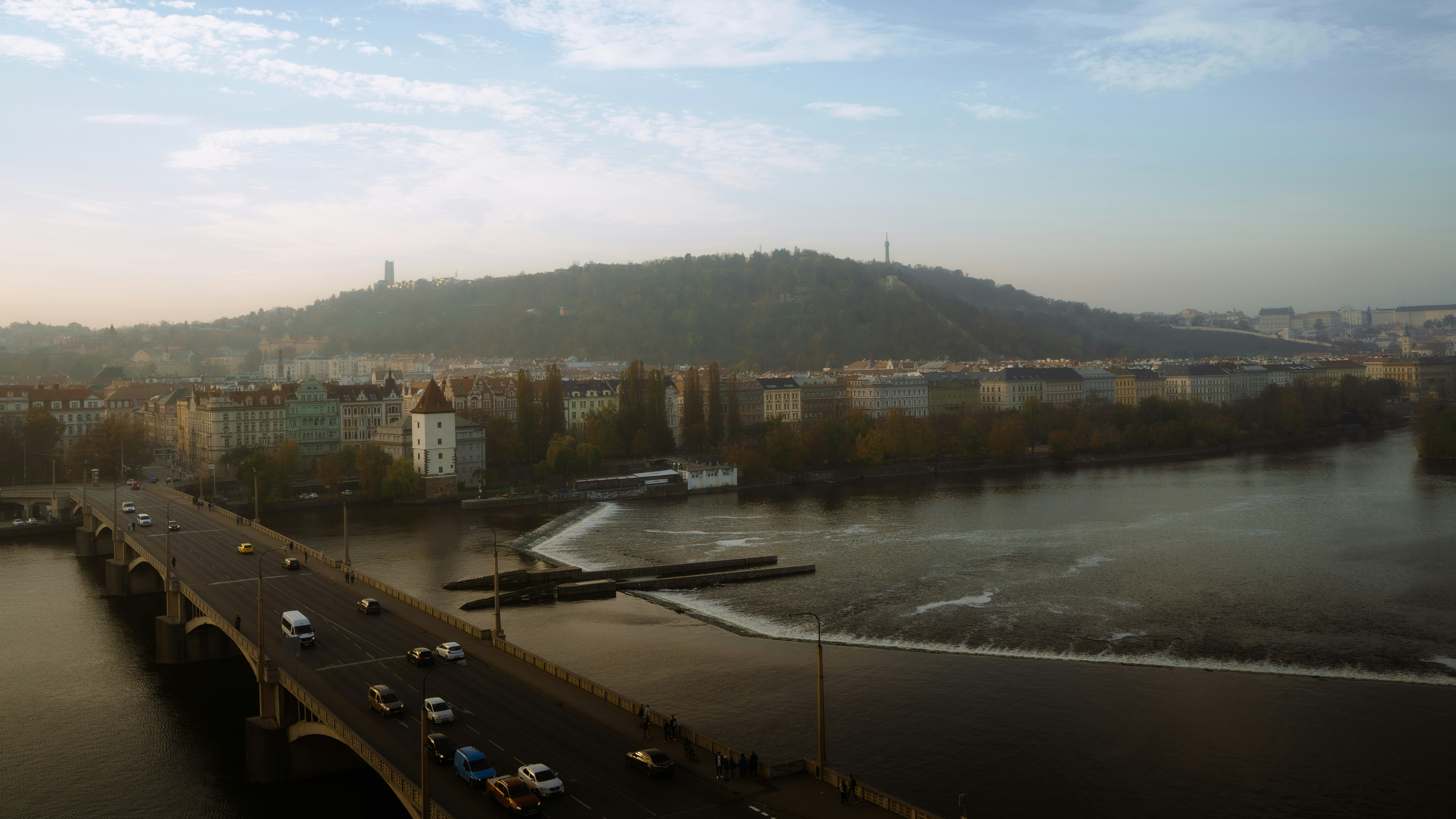 a bridge over a river with cars driving on it