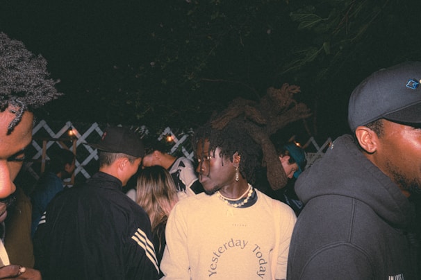 A candid moment of friends dressed in Lumina Apparel enjoying an outdoor evening gathering.