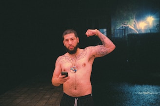 Man showing off a full sleeve of intricate black waterproof temporary tattoos while wearing a leather jacket