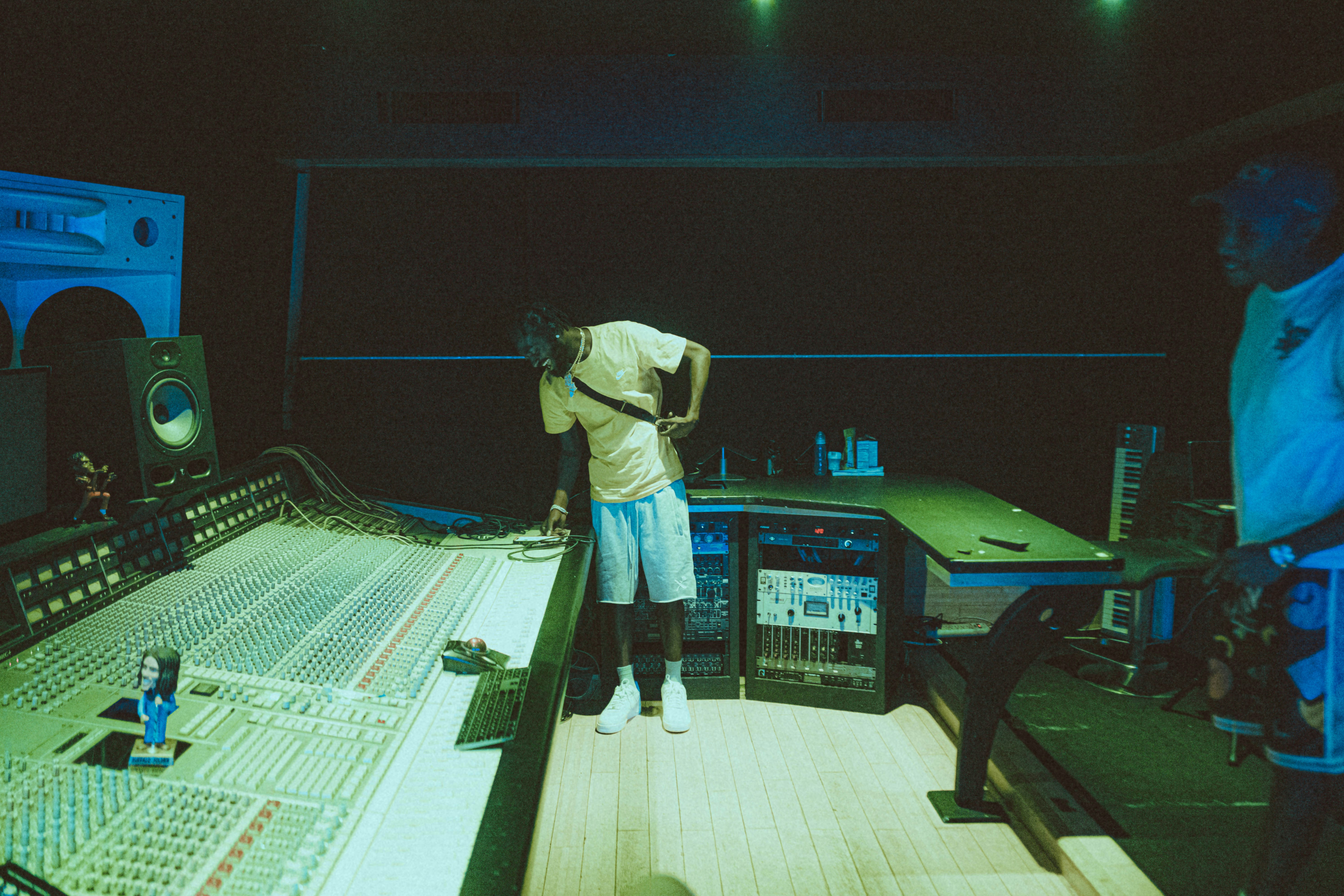 a man standing in front of a sound board
