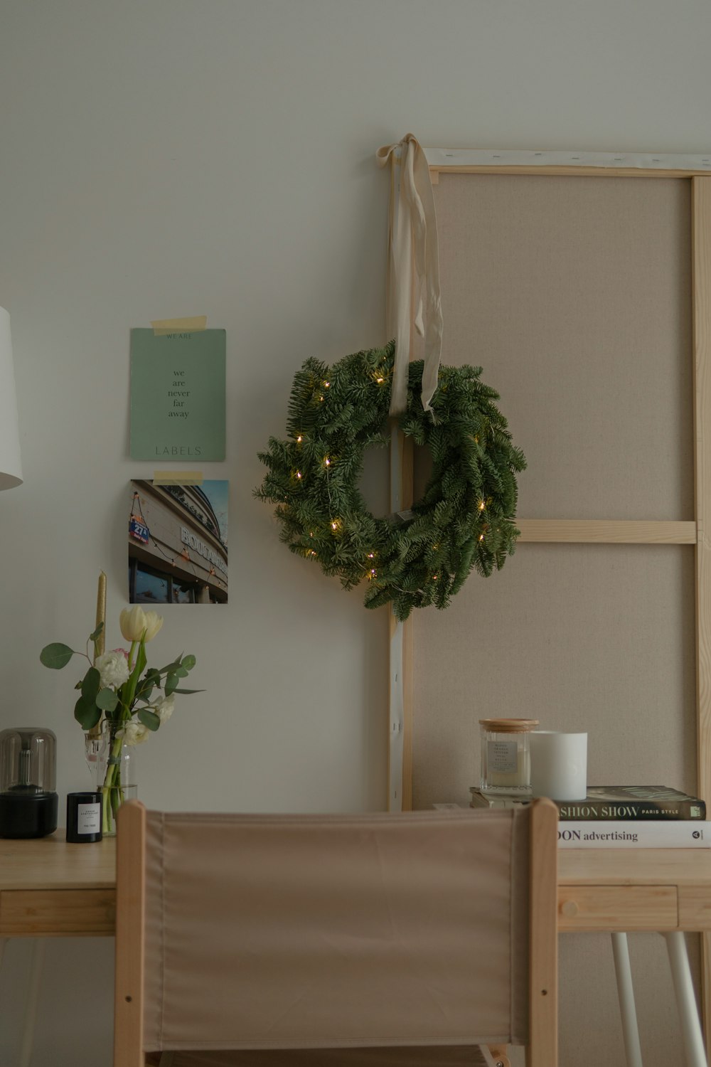 a wreath on a wall next to a chair