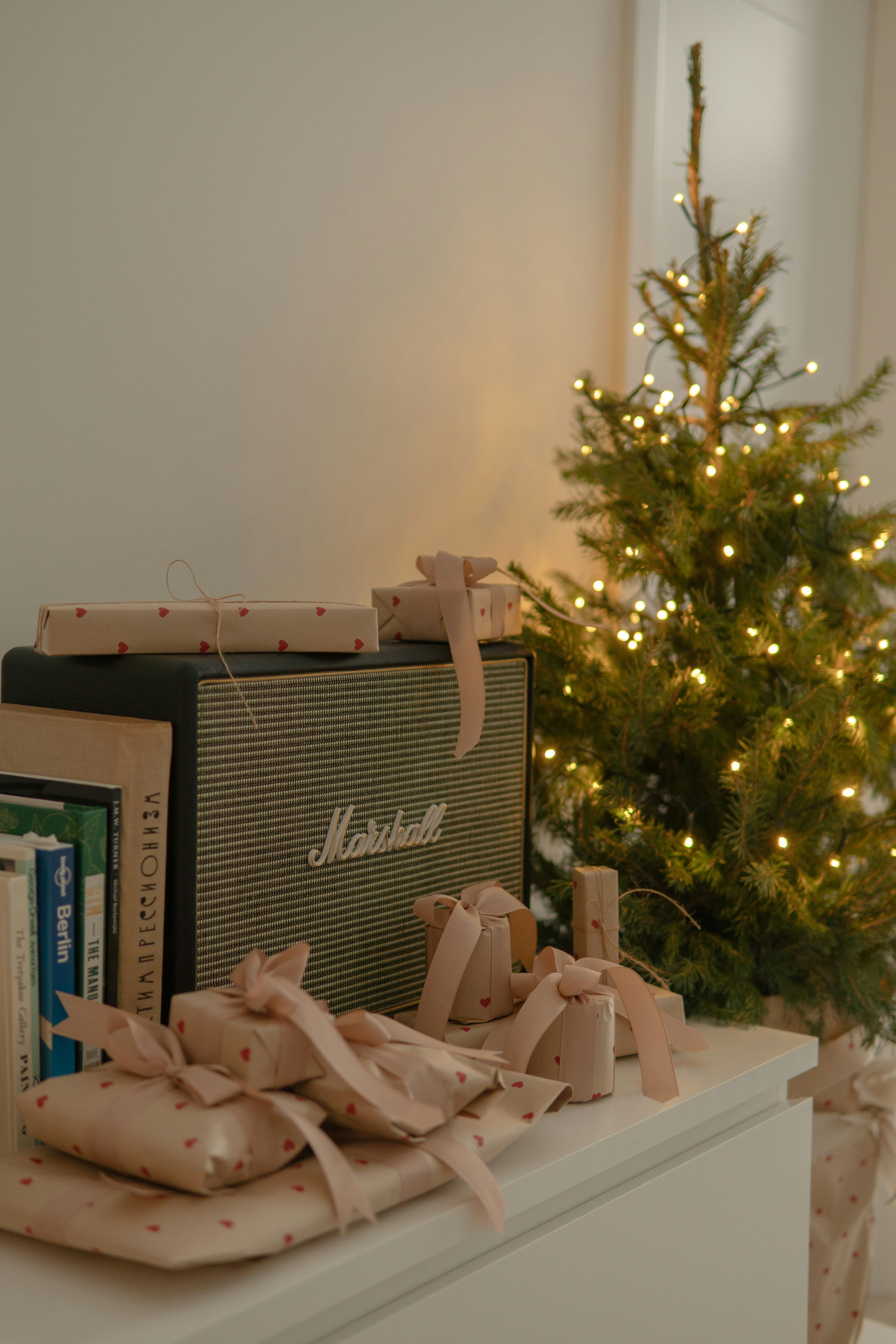 a small christmas tree is in the corner of a room