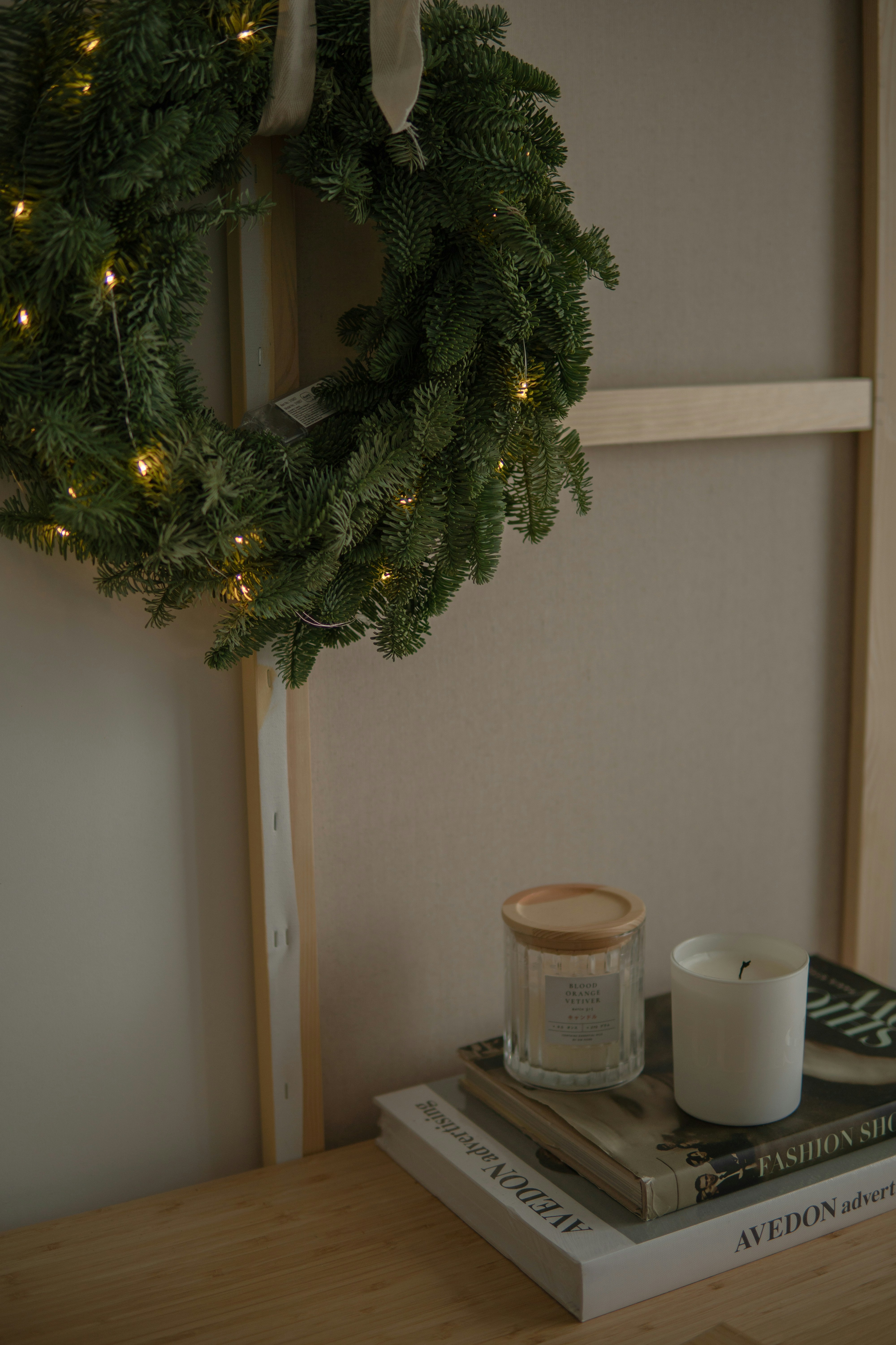 a wreath and two books on a table