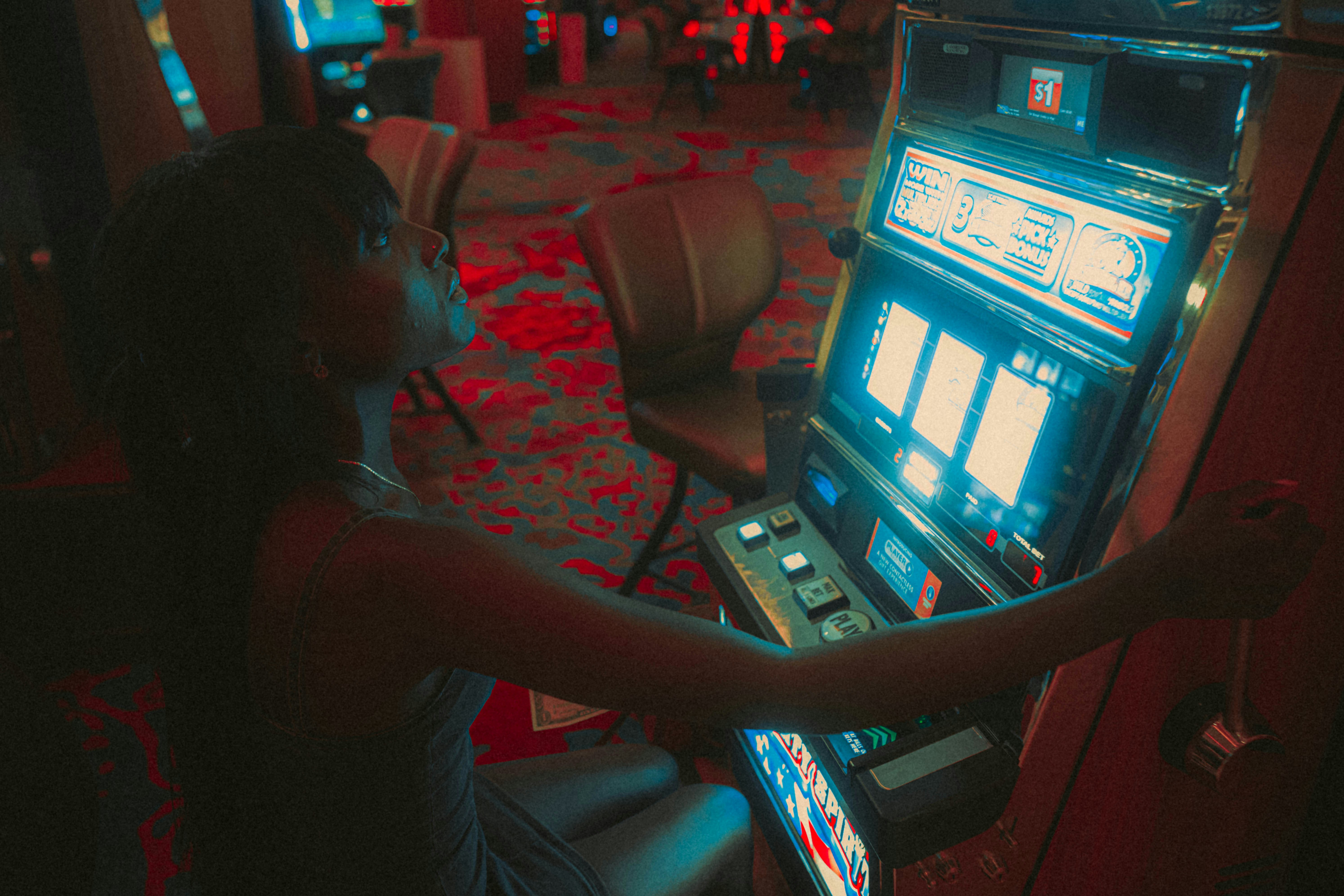 a woman playing a slot machine in a casino