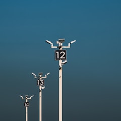 a number of street lights with a sky background