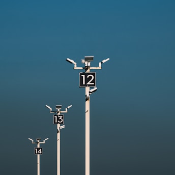 a number of street lights with a sky background