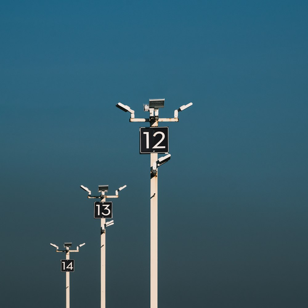 a number of street lights with a sky background