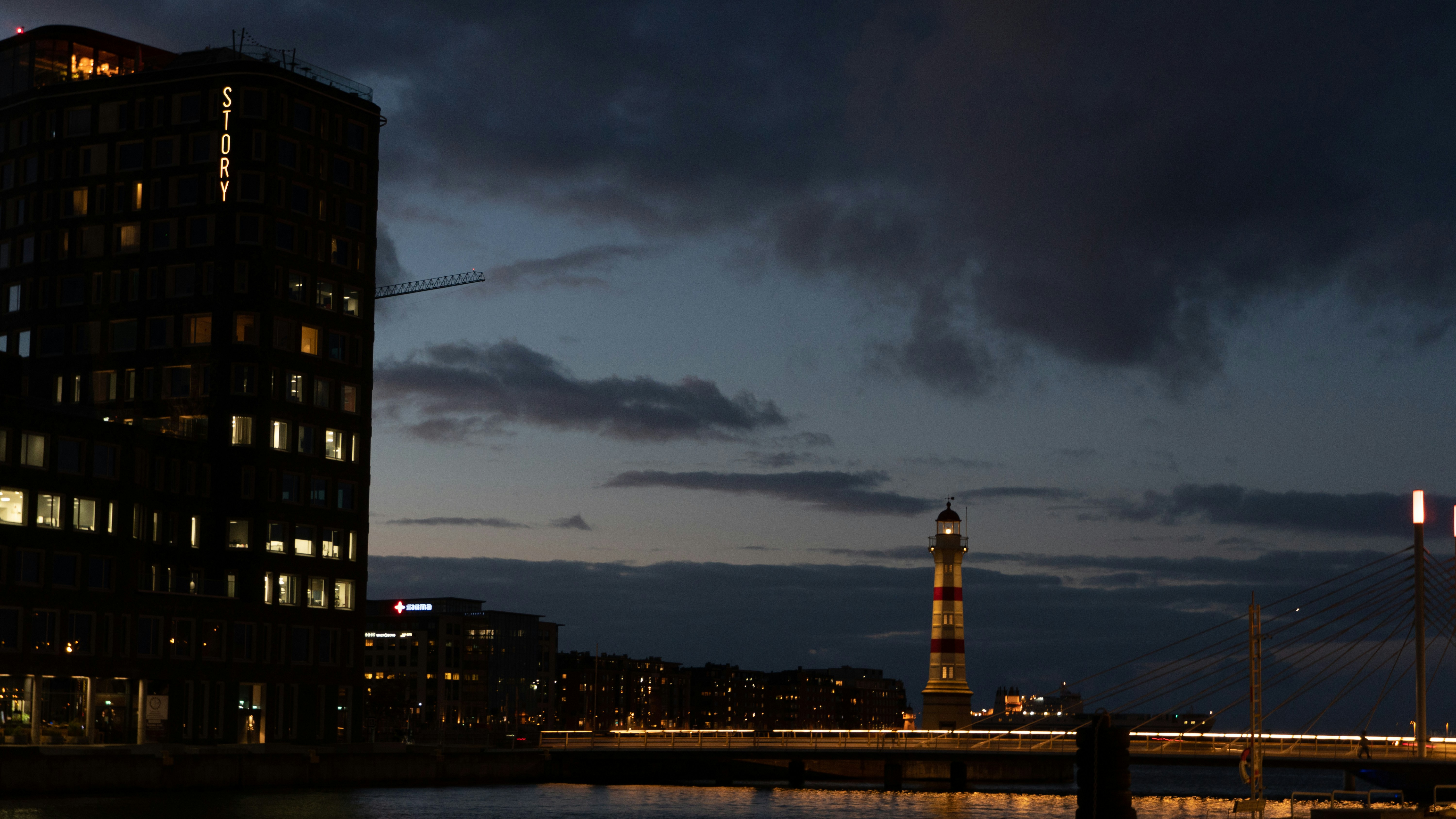 a tall building sitting next to a body of water