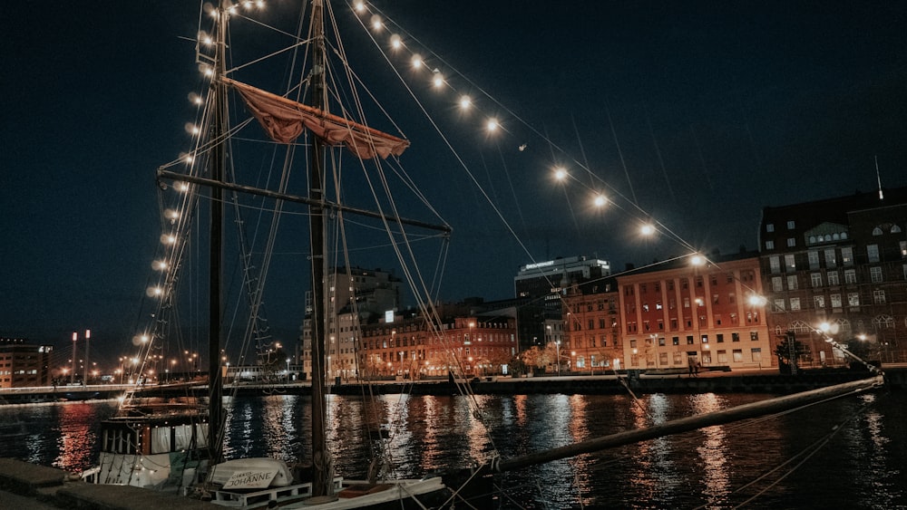 a boat is docked in a harbor at night