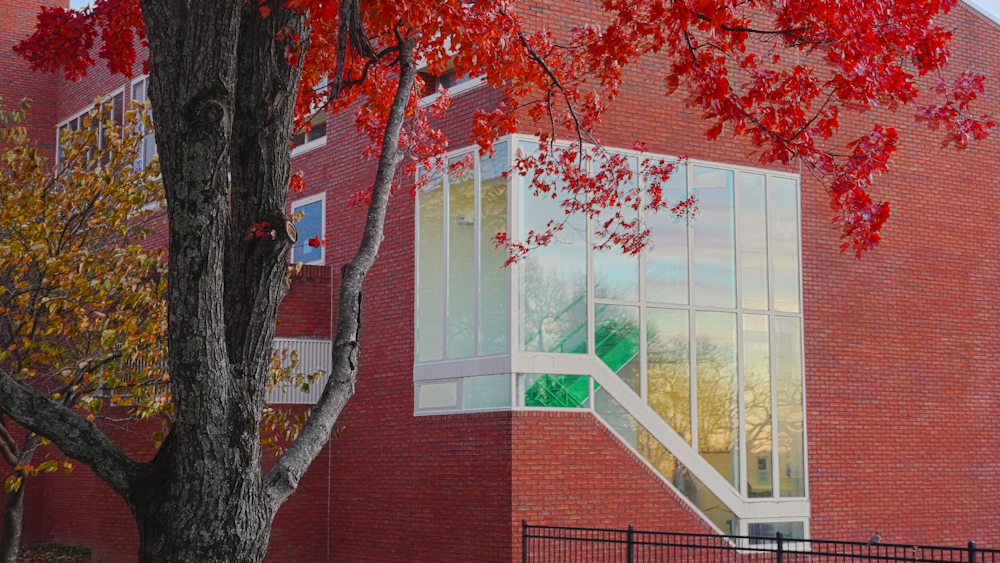 a red brick building with a tree in front of it