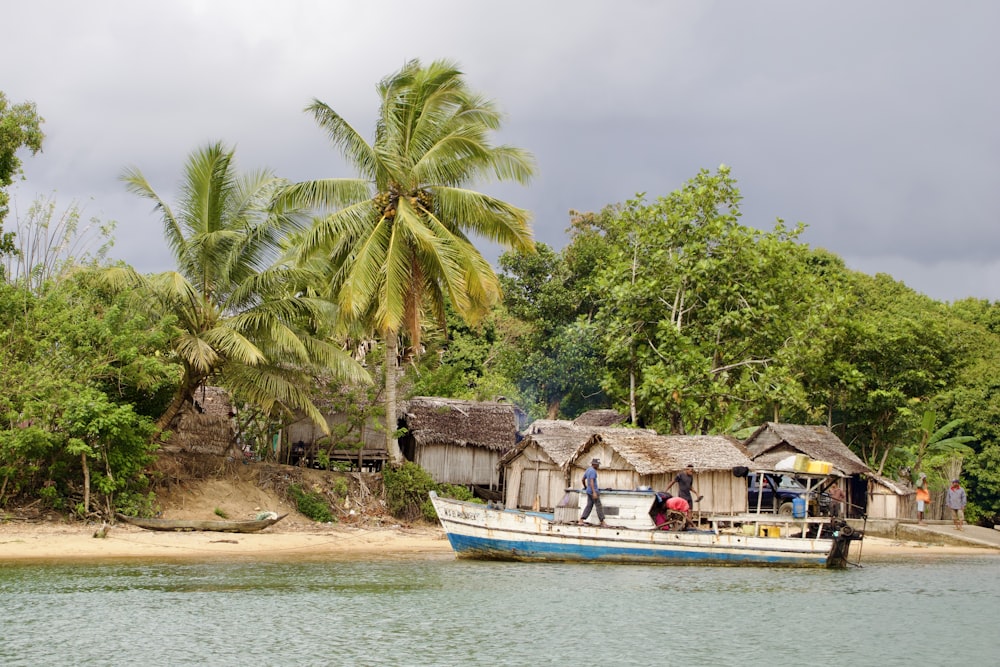 a boat on a body of water near a beach