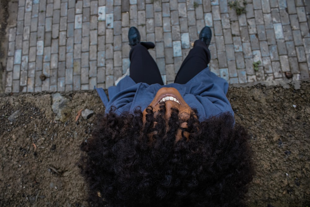 a woman laying on the ground with her hair in the air