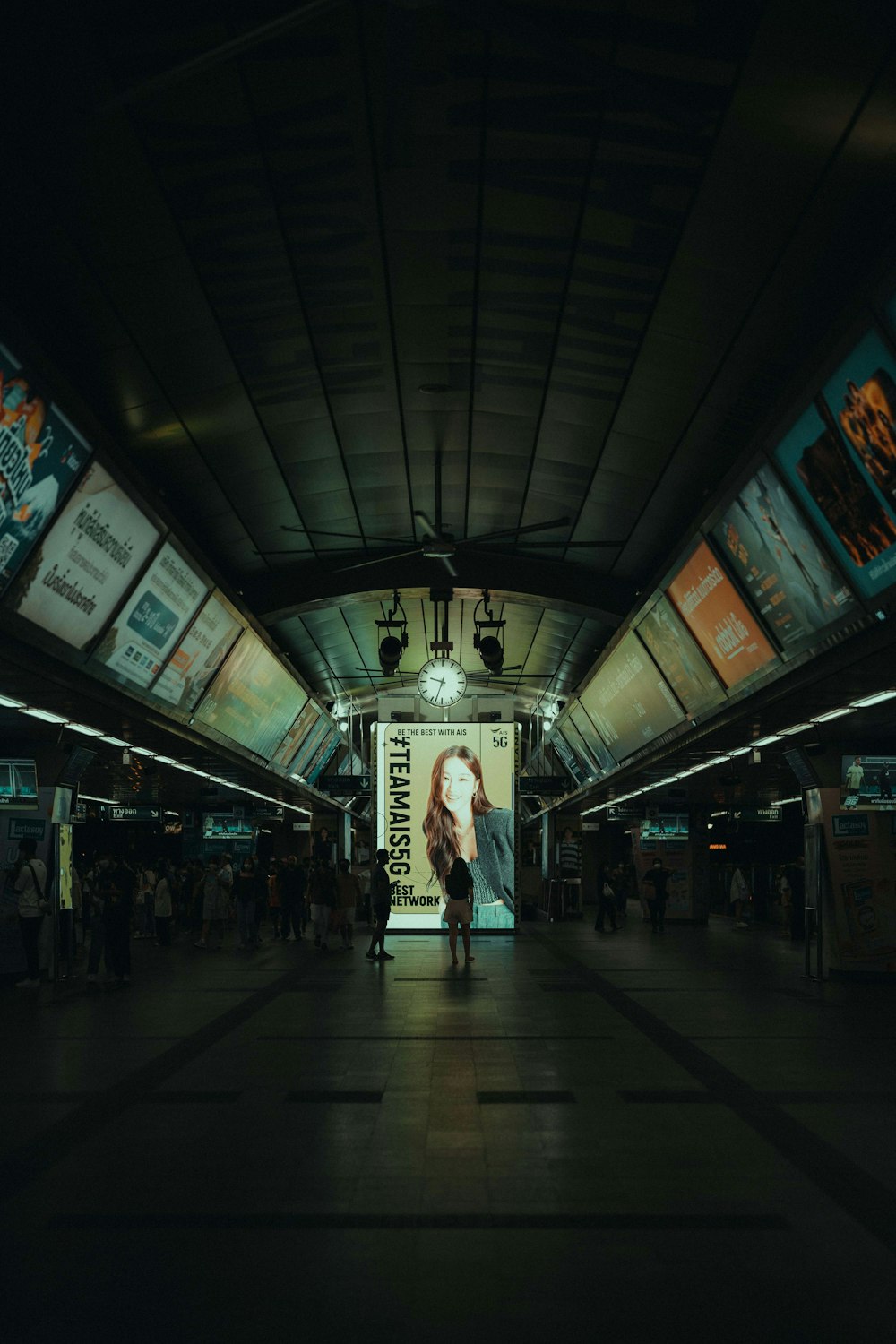 a woman is walking through a subway station