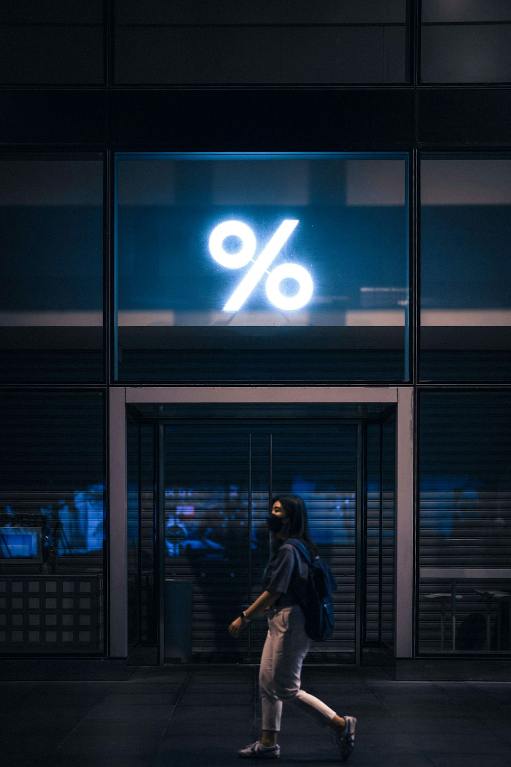 a person walking in front of a building