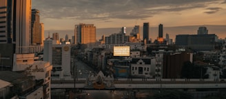 a view of a city skyline with a bridge in the foreground