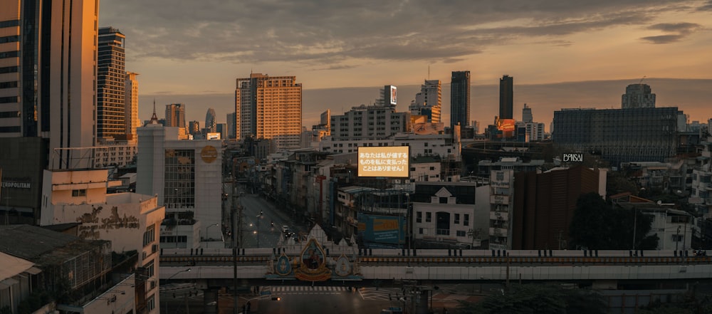 a view of a city skyline with a bridge in the foreground