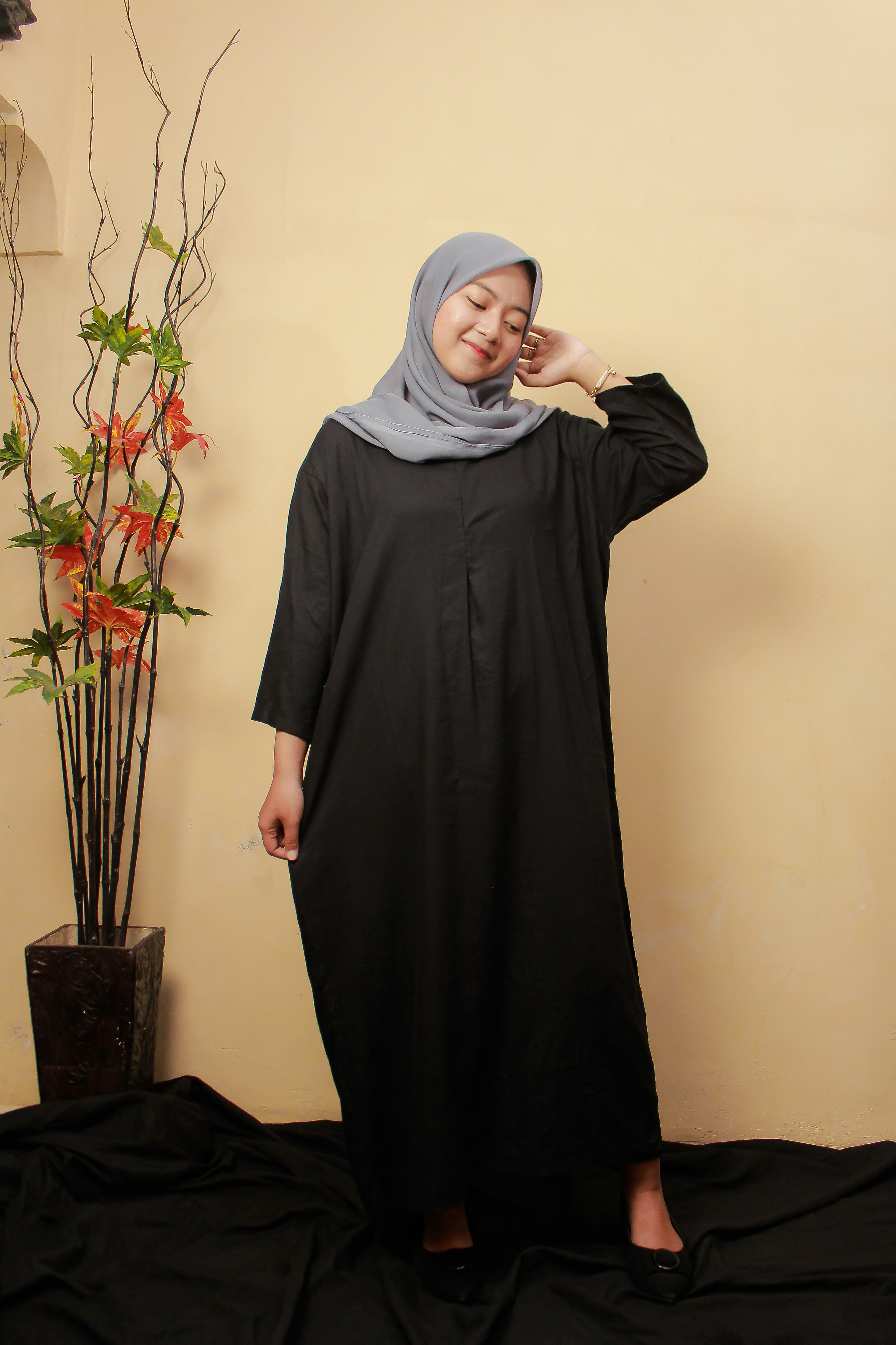 a woman in a hijab poses for a picture