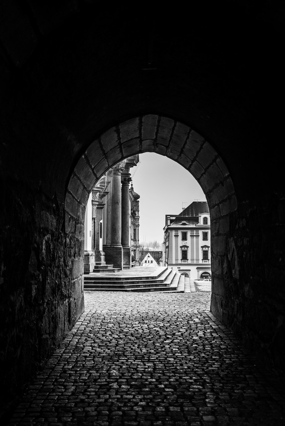 a black and white photo of a brick walkway