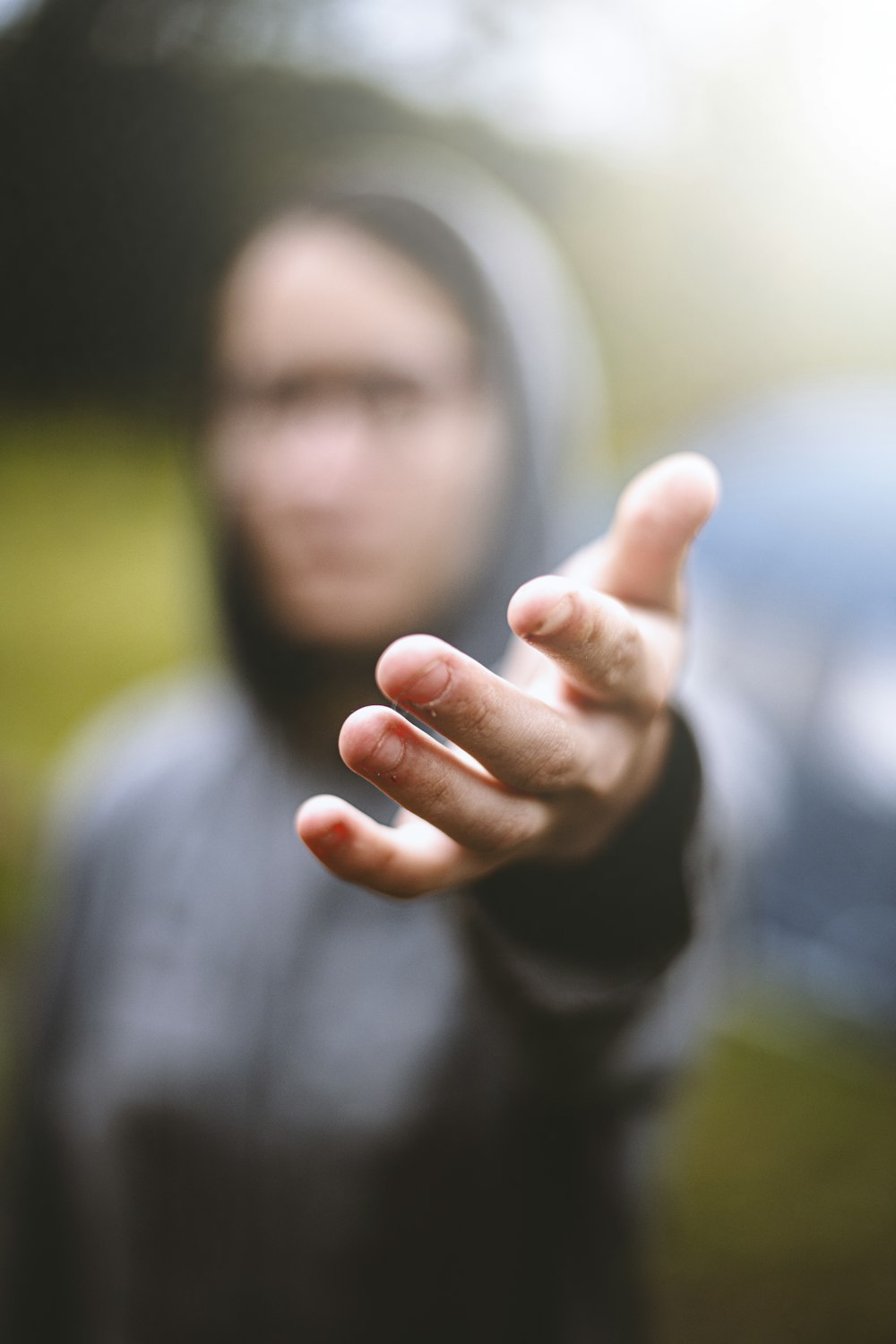 a blurry image of a person holding out their hand