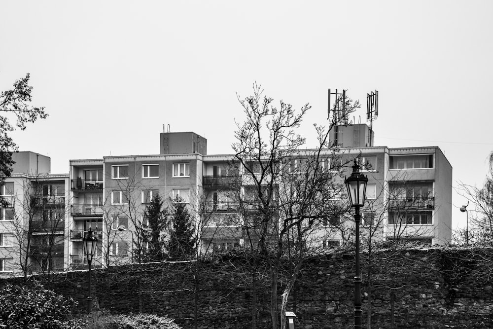 a black and white photo of a building and a street light