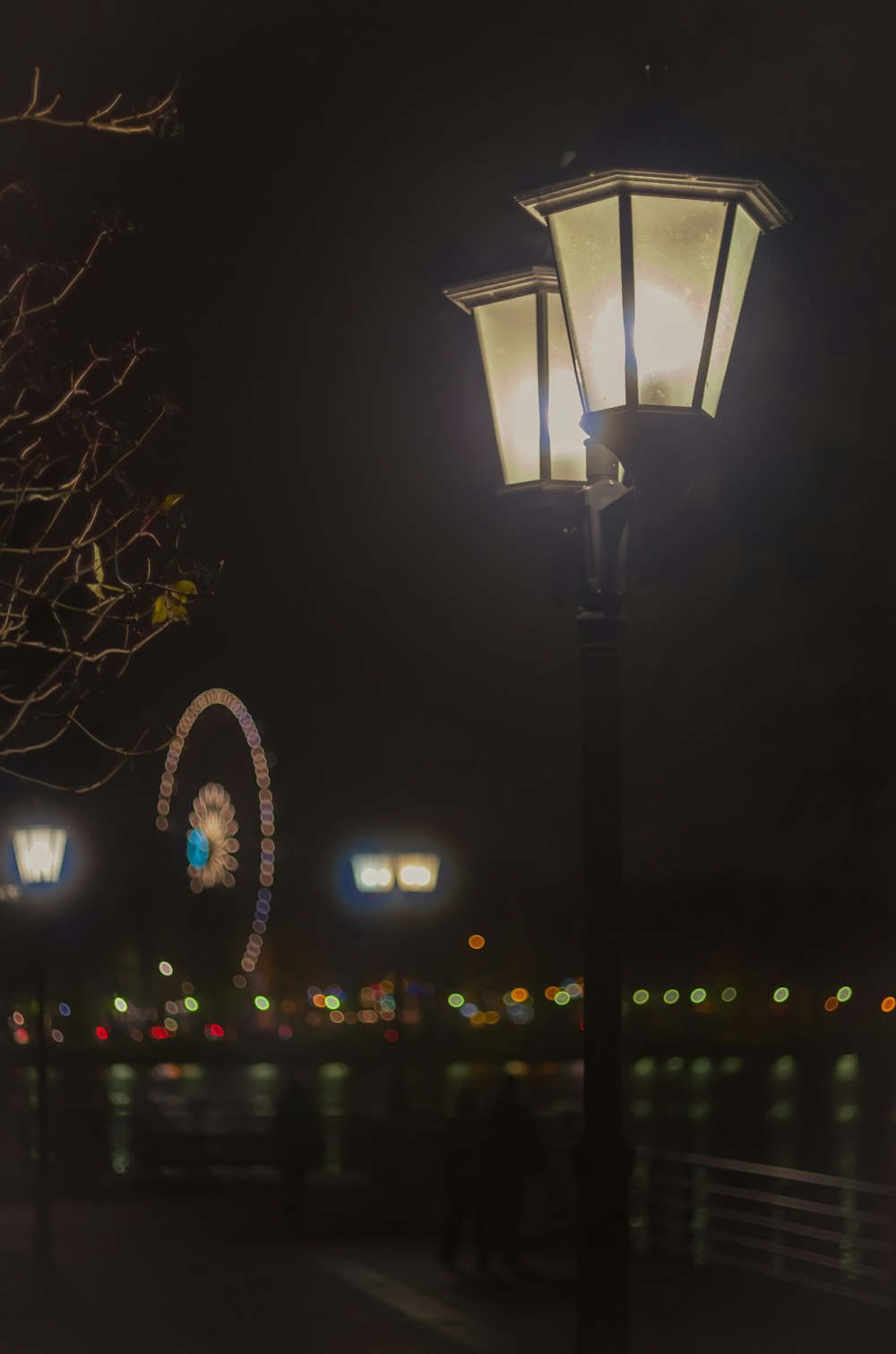 a street light sitting next to a tree