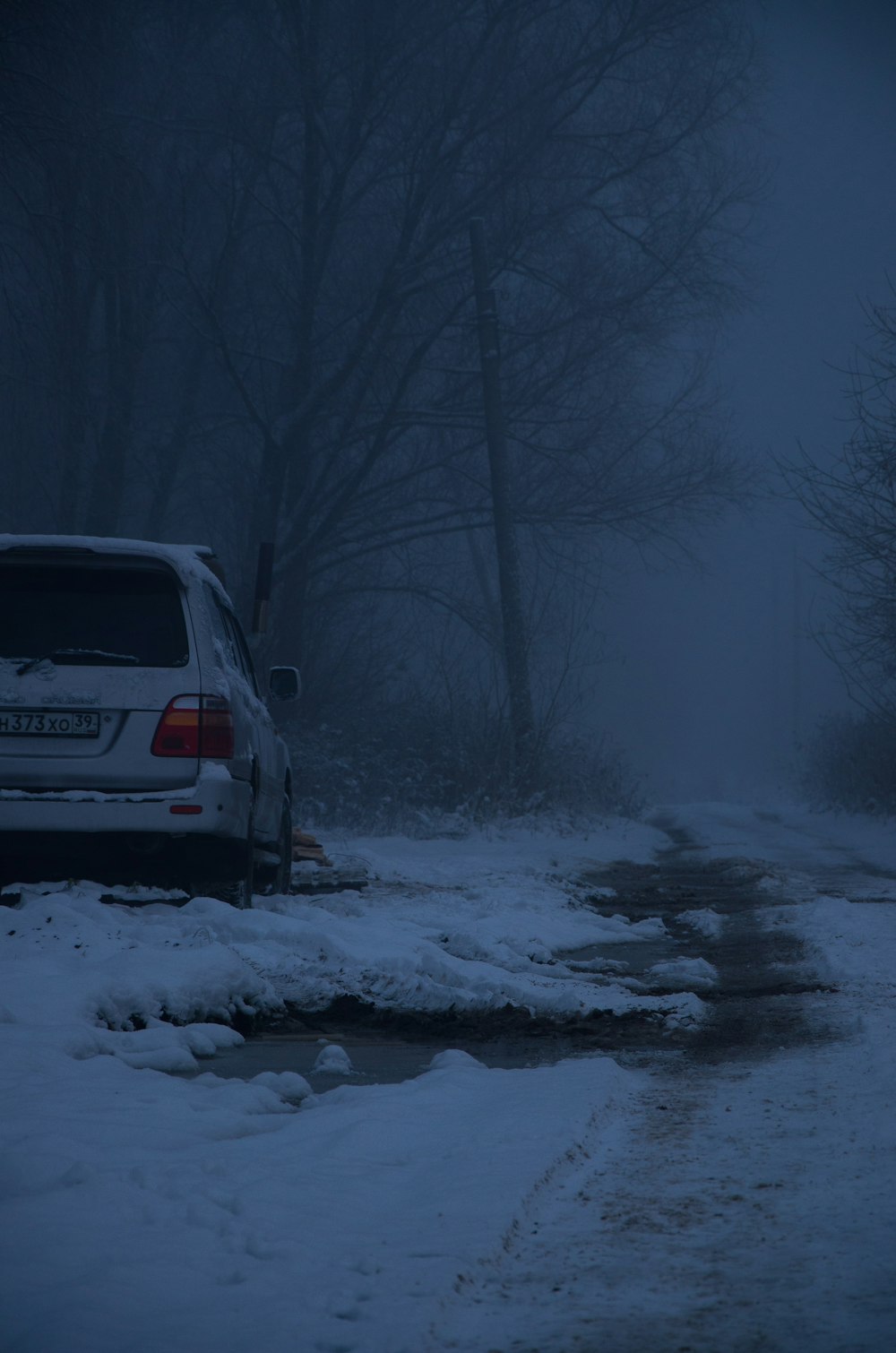 a car is parked on a snowy road