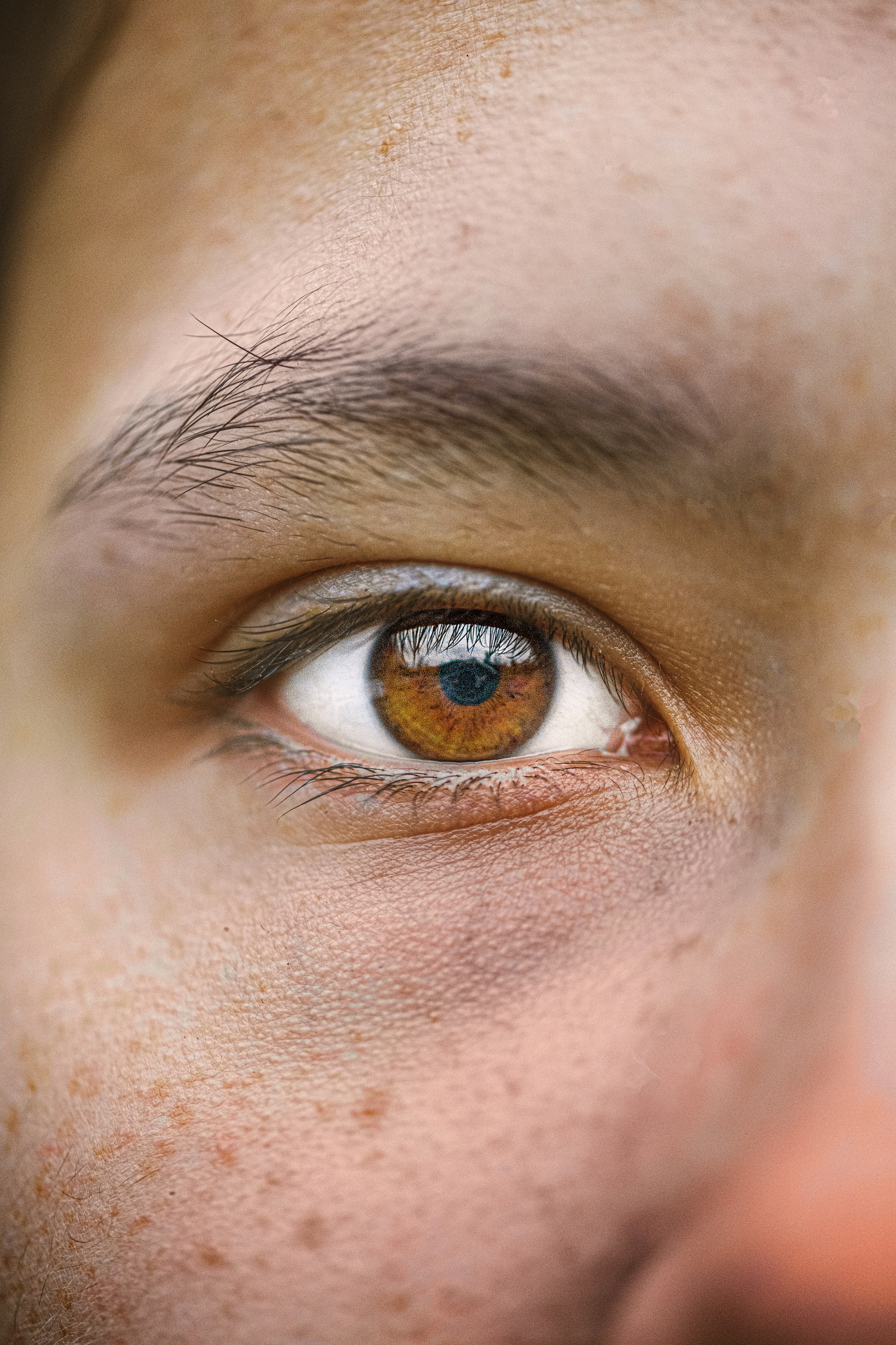 a close up of a person with freckles on their eyes